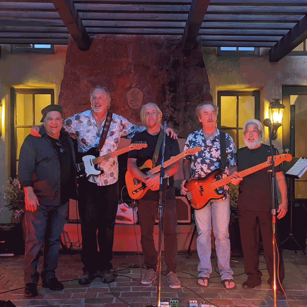 Red stage lighting illuminates live band